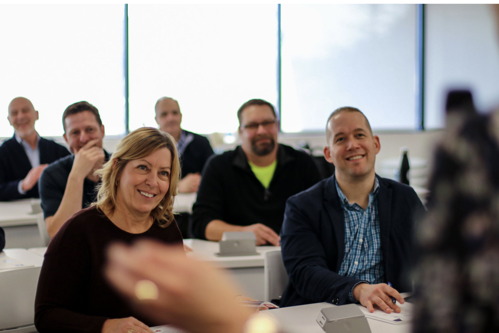 People learning Talent Optimization in a conference room