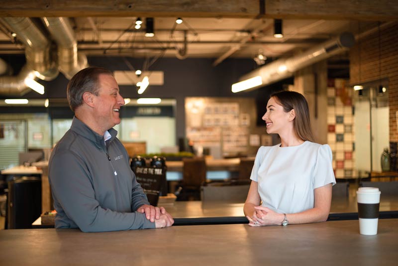 Employees talk over coffee